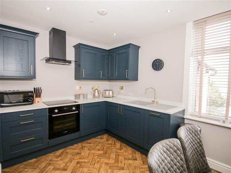 This is the kitchen at Darcey���s Place by the Sea in Rhos-On-Sea